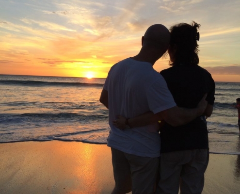 Couple on a beach watching the sunset in Guanacaste Costa Rica