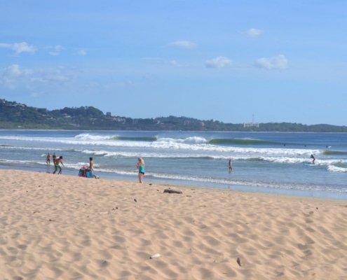 People surfing the waves at Playa Grande Beach in Guanacaste Costa Rica