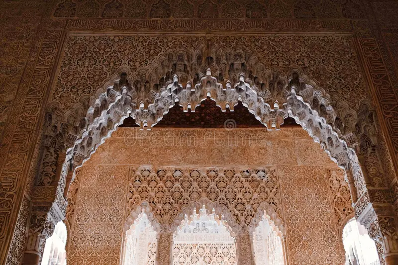 Elaborate carved plaster walls and muqarnas ceilings inside the Nasrid Palaces of the Alhambra