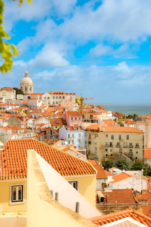 View over the rooftops of the Alfama district in Lisbon toward the Tagus River
